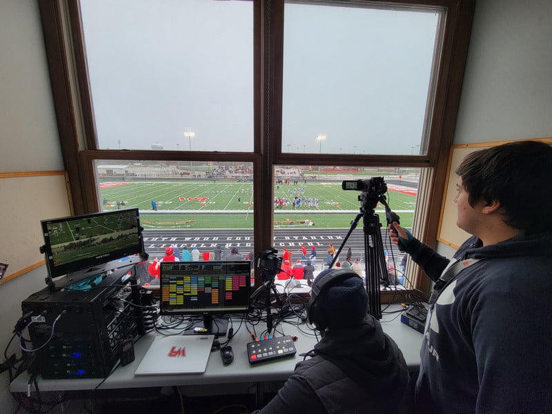students working in a press box