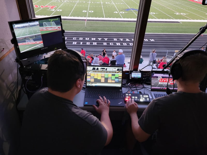 students working in the press box