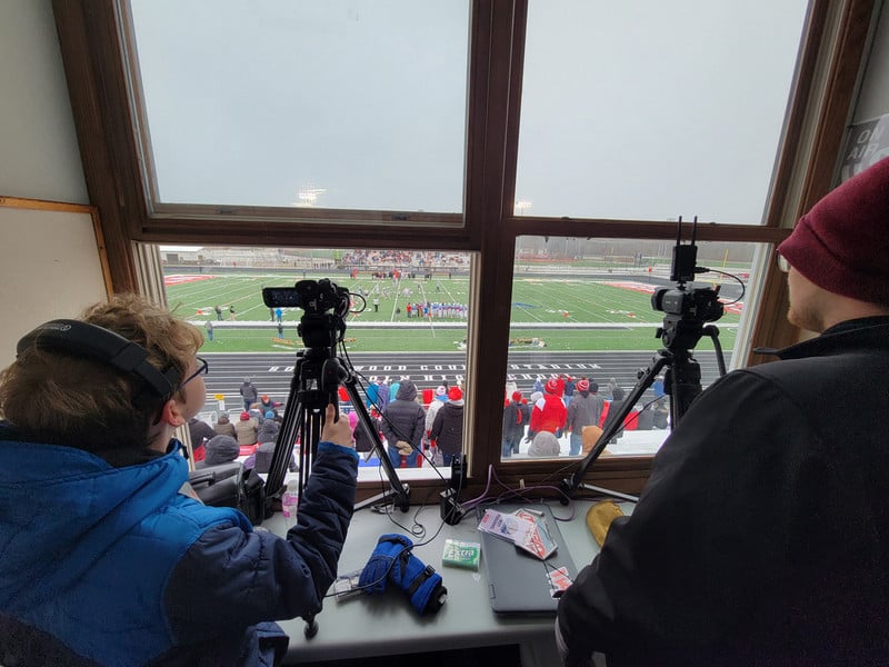 students working in a press box