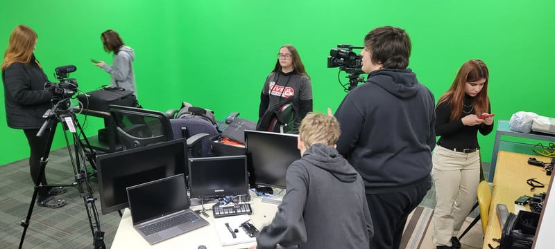 students working in front of a green screen